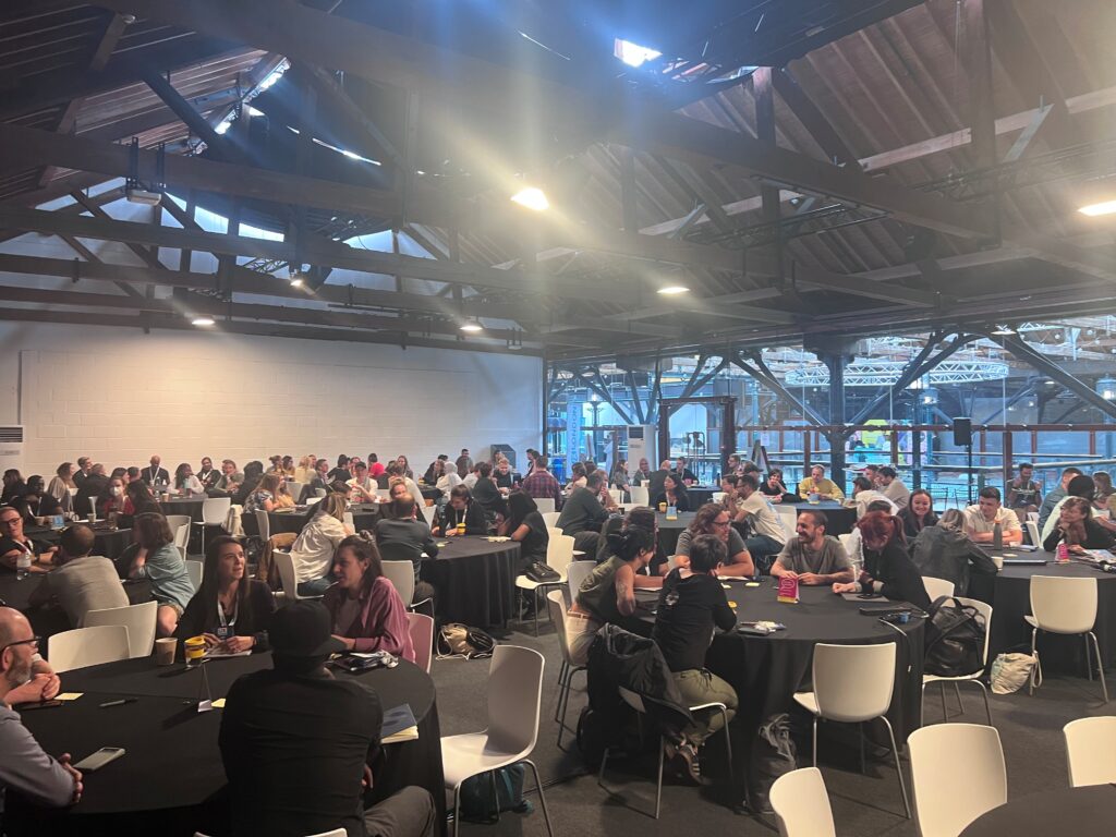 a crowd of people in a workshop room